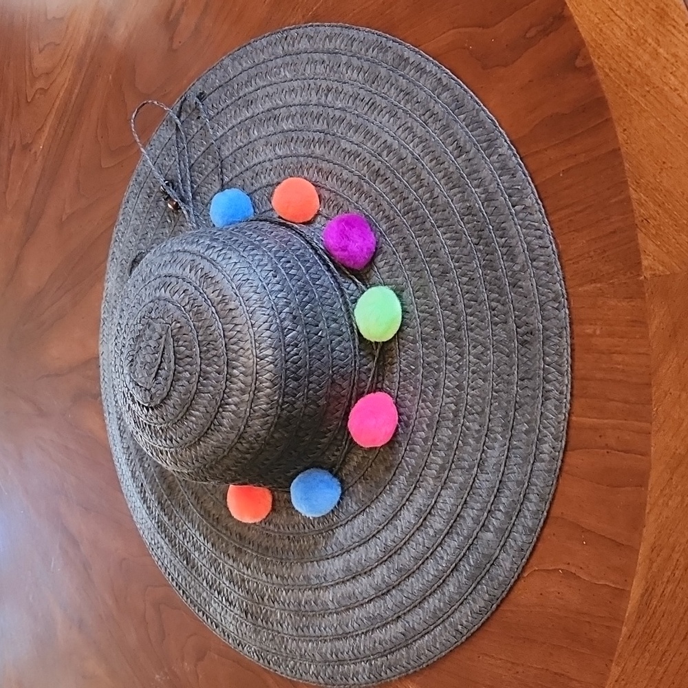 Black straw hat with rainbow pompoms